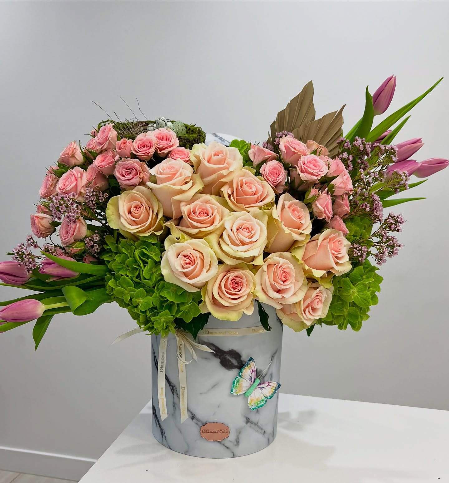 Blush and peach roses, green hydrangea and lavender tulips in a blush Diamond Vase box for a baby shower